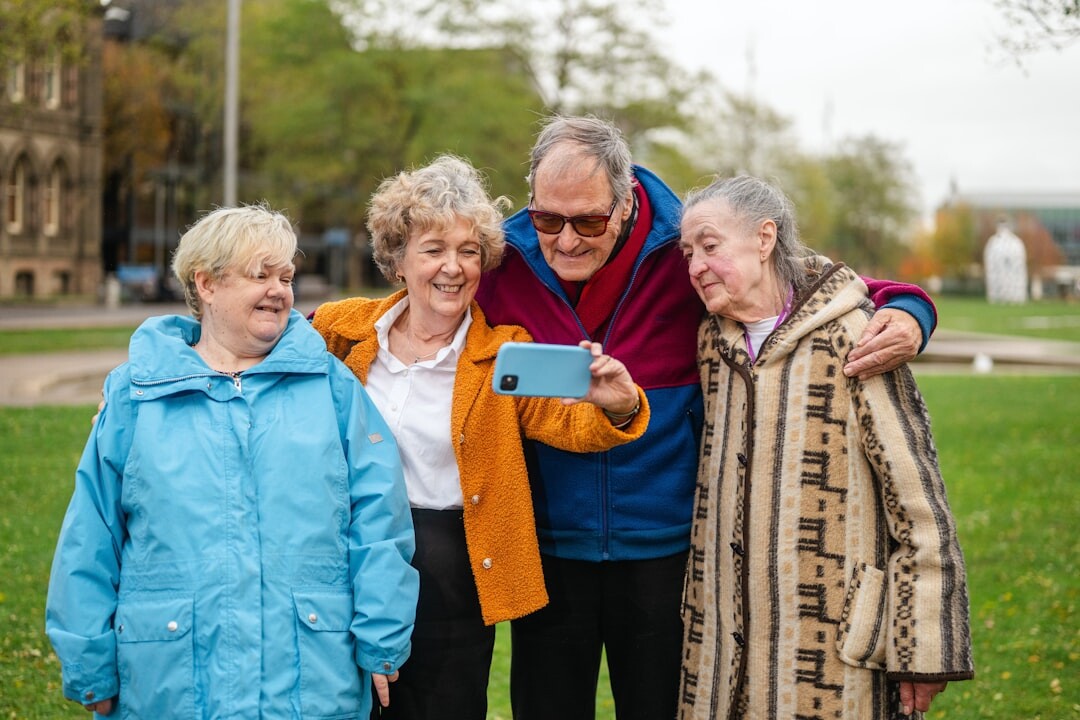 Group of smiling active senior citizens spending time together outdoors